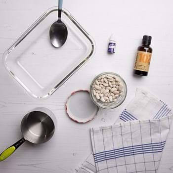 Materials to make scented beans, including white beans, purple food colouring and essential oils