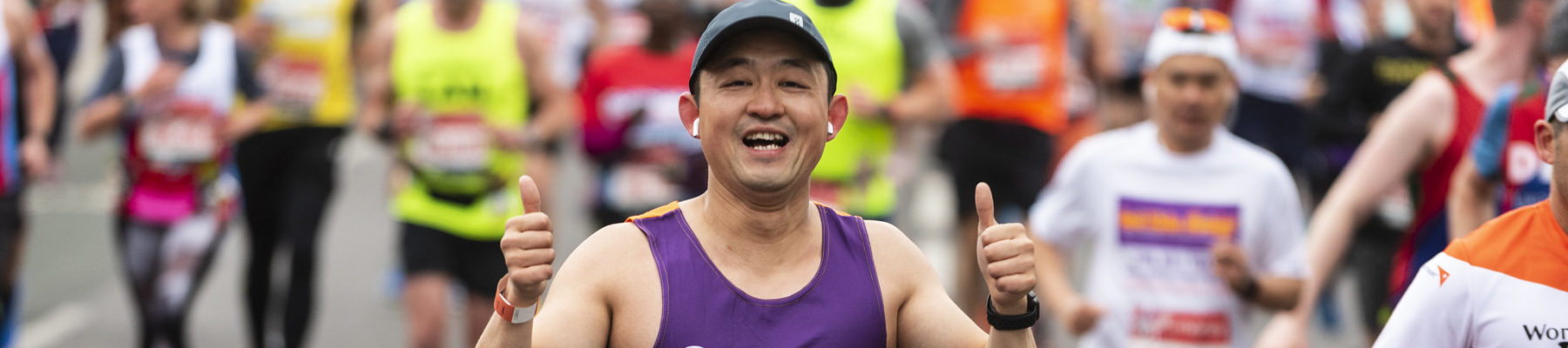 A runner in a Sense vest has his thumbs up
