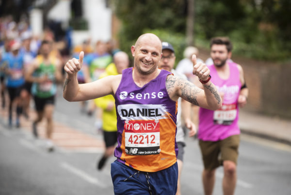 Sense marathon runner smiling at camera