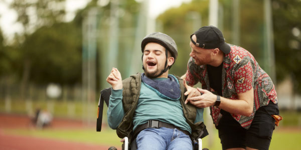 Carer talking to young man in wheelchair