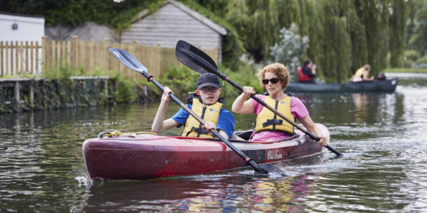 George Cook and a Sense volunteer canoeing on their Sense Holiday in 2021.