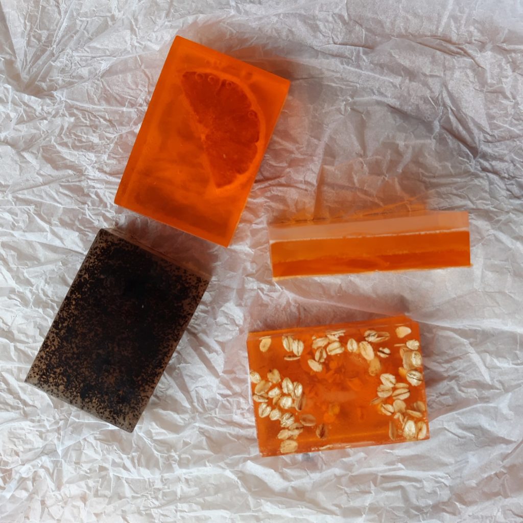 A selection of homemade soaps that are orange and darker browns