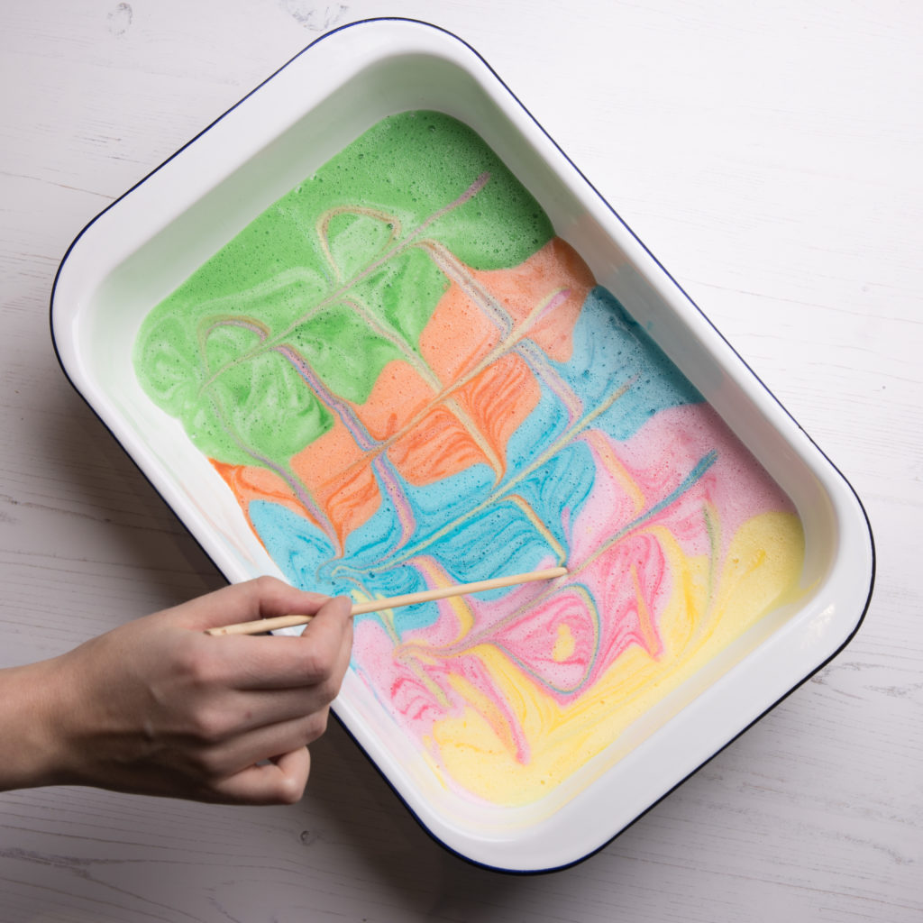 A tray of foamy pastel-coloured paint