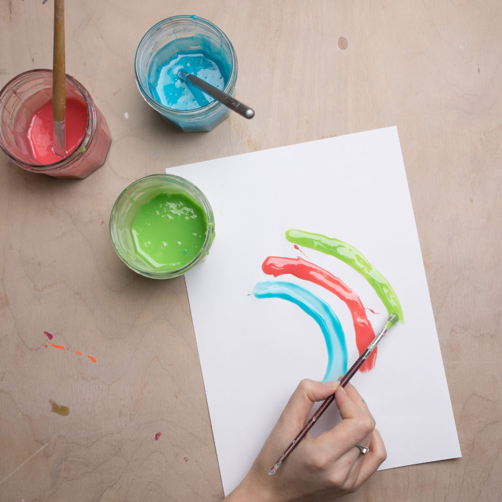 Painting a rainbow with edible fingerpaint