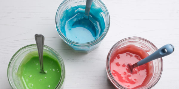 Three pots of paint in green, blue and red