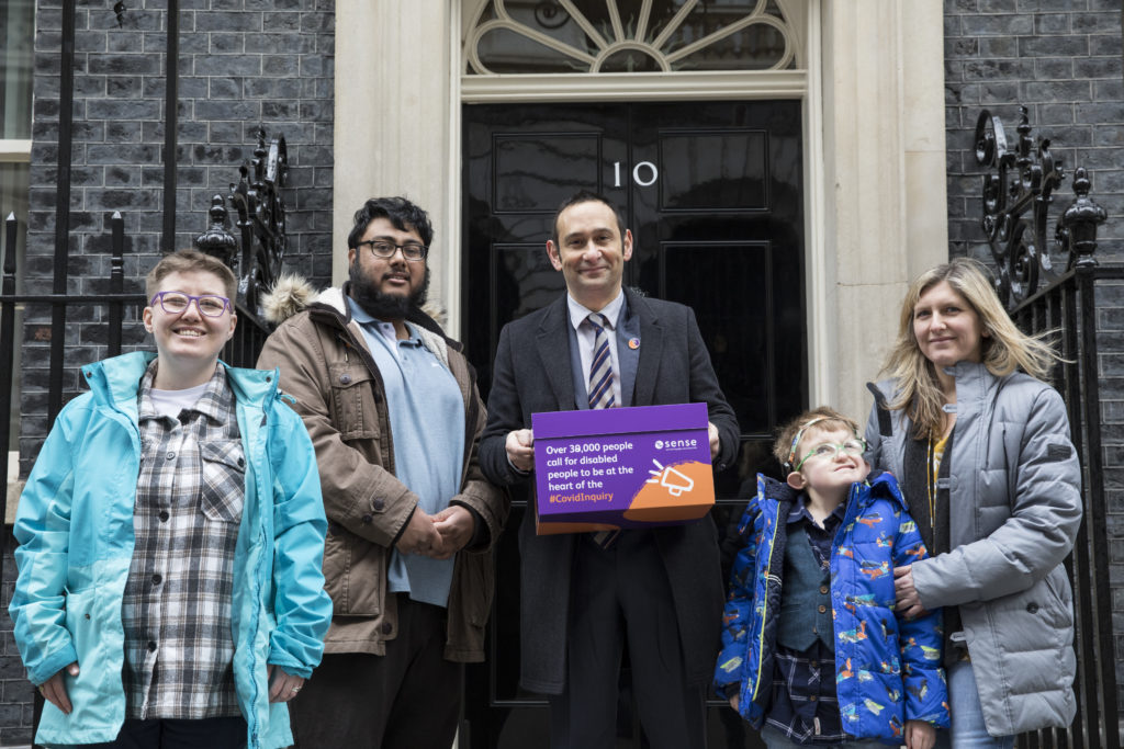 5 people stand with a petition box in front of 10 Downing St