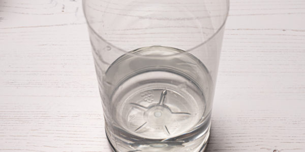 Image shows bottle bottom with water in it.