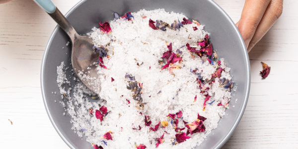 Stirring the bowl of salts and dried flowers