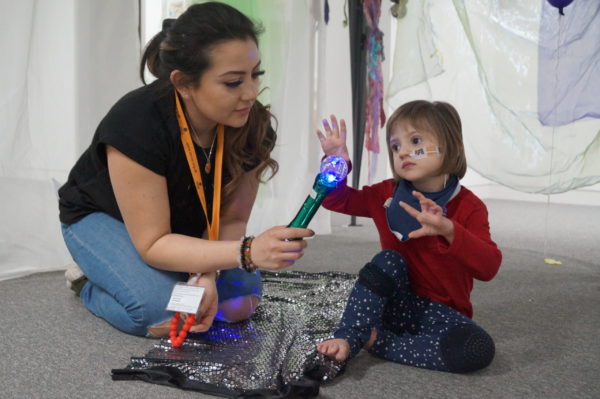 child and support worker playing with a toy
