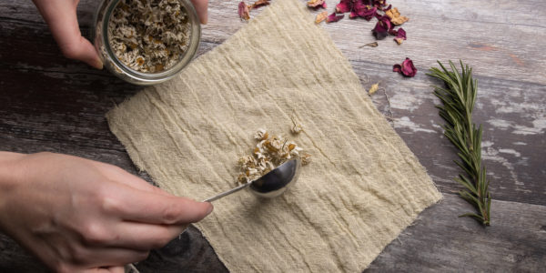 Adding a spoon full of oats to the centre of a square piece of linen