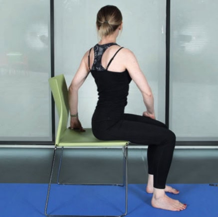 woman sitting on chair bending to left
