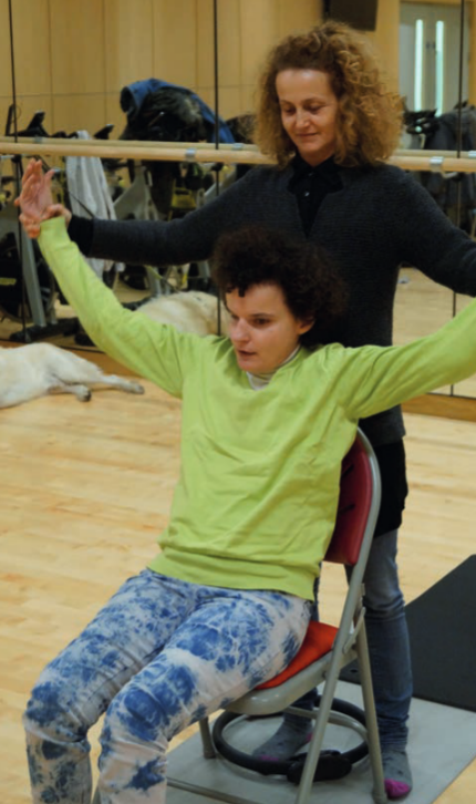 Odyssey practises yoga with help from a practitioner