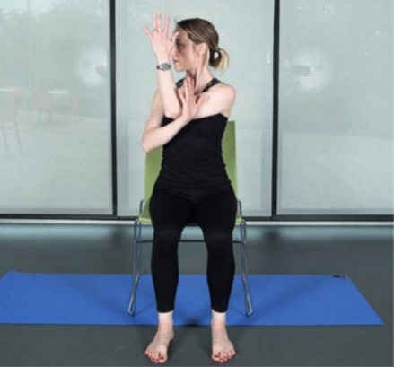 woman with her left arm bent across her body