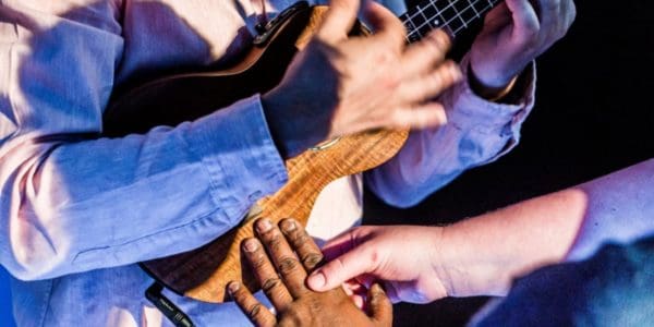 a group of people playing a ukulele