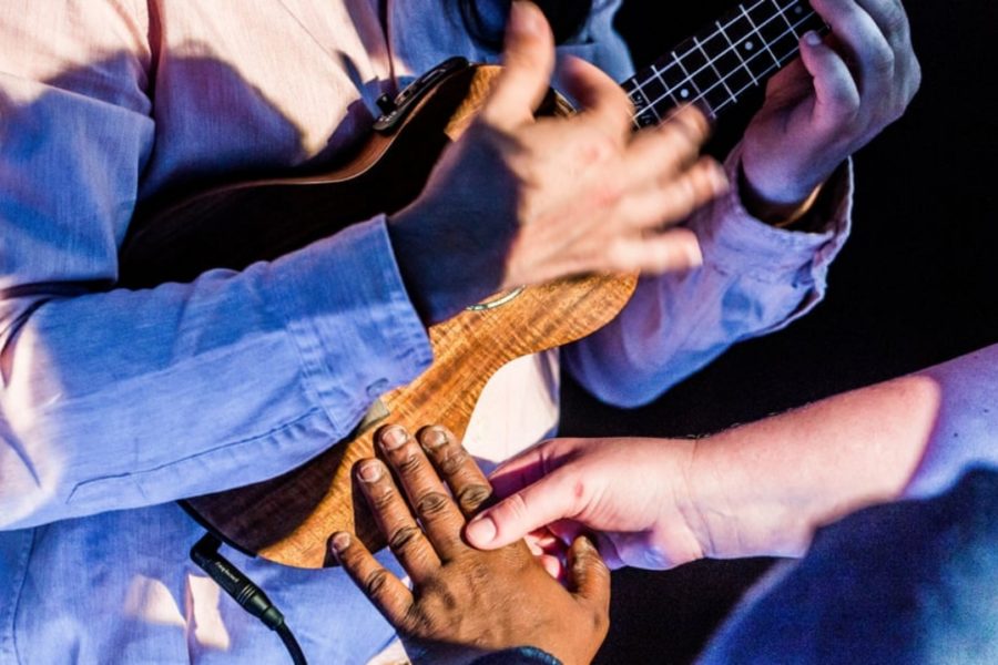 a group of people playing a ukulele