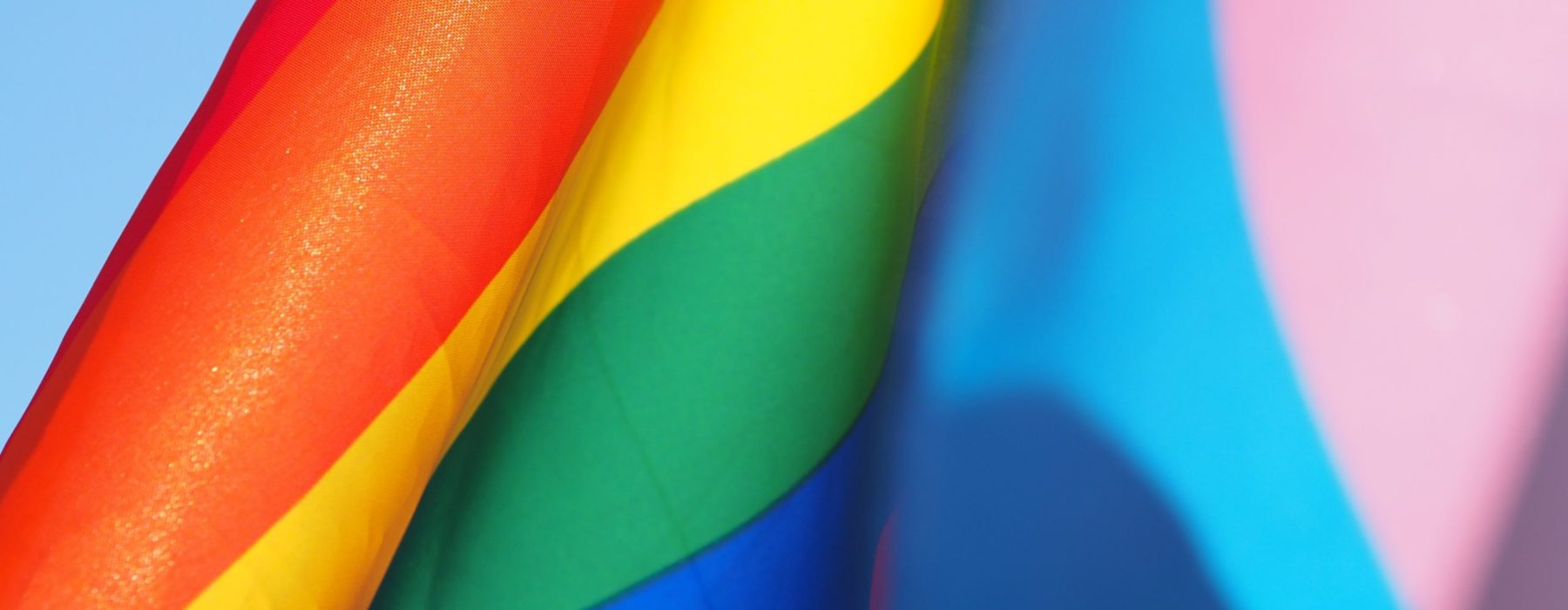 A close up of a pride rainbow flag with red, orange, yellow, green, pink and blue