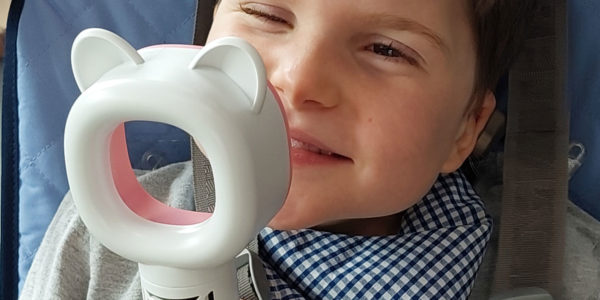 Little boy, Luca, smiling to a sensory toy