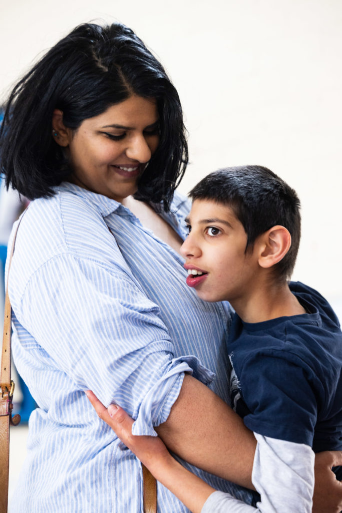 Nakita hugging and smiling at her son, Nayan.