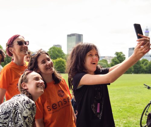 a girl takes a selfie with three other people