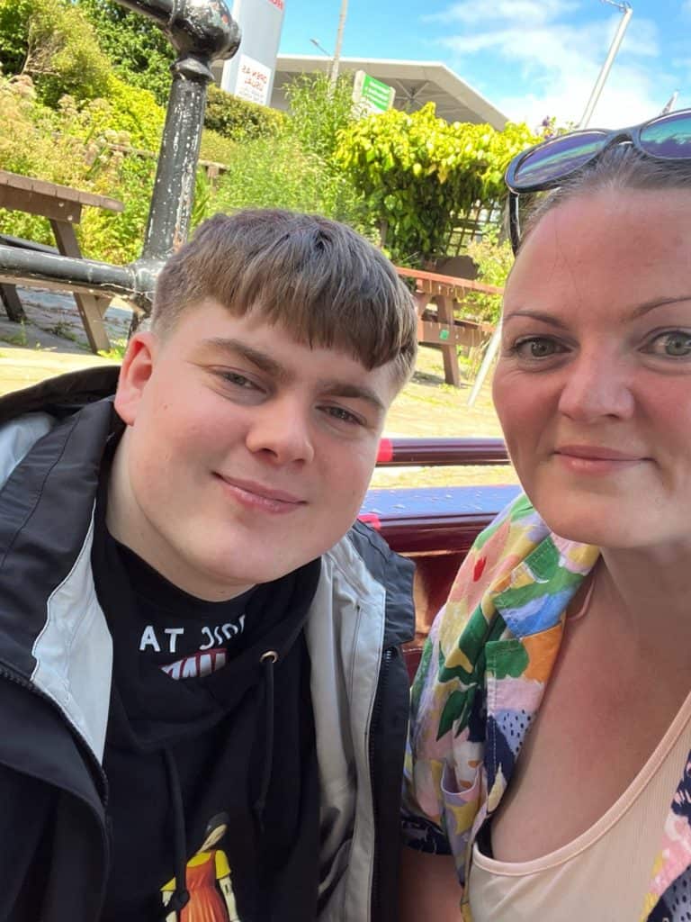 Anna with her son, Charlie, smiling in the sunshine.