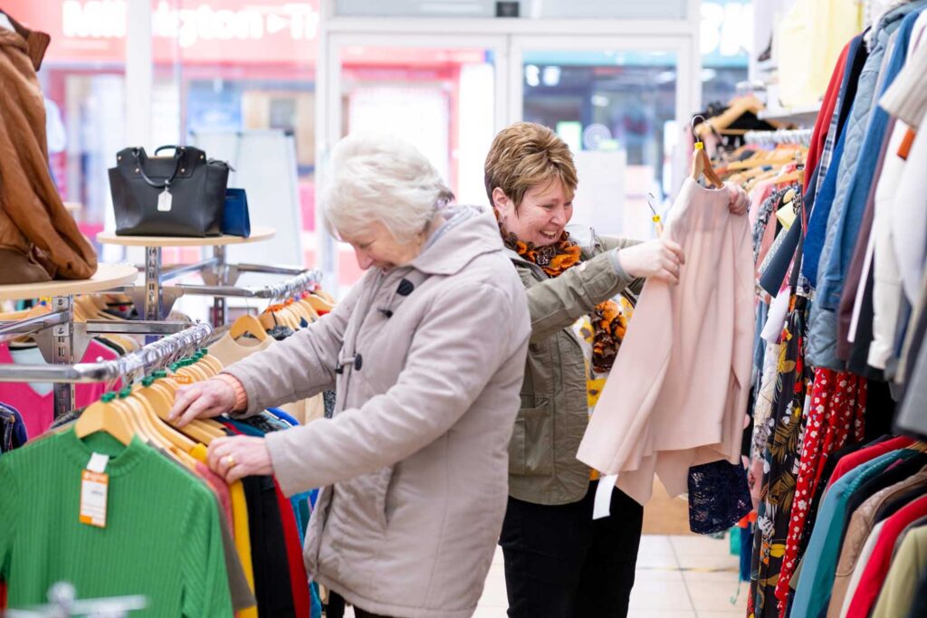 Two shoppers search through clothes in a Sense shop