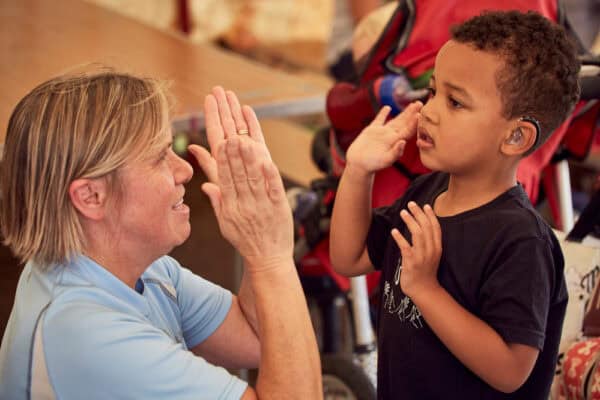 Child high-fives an older woman