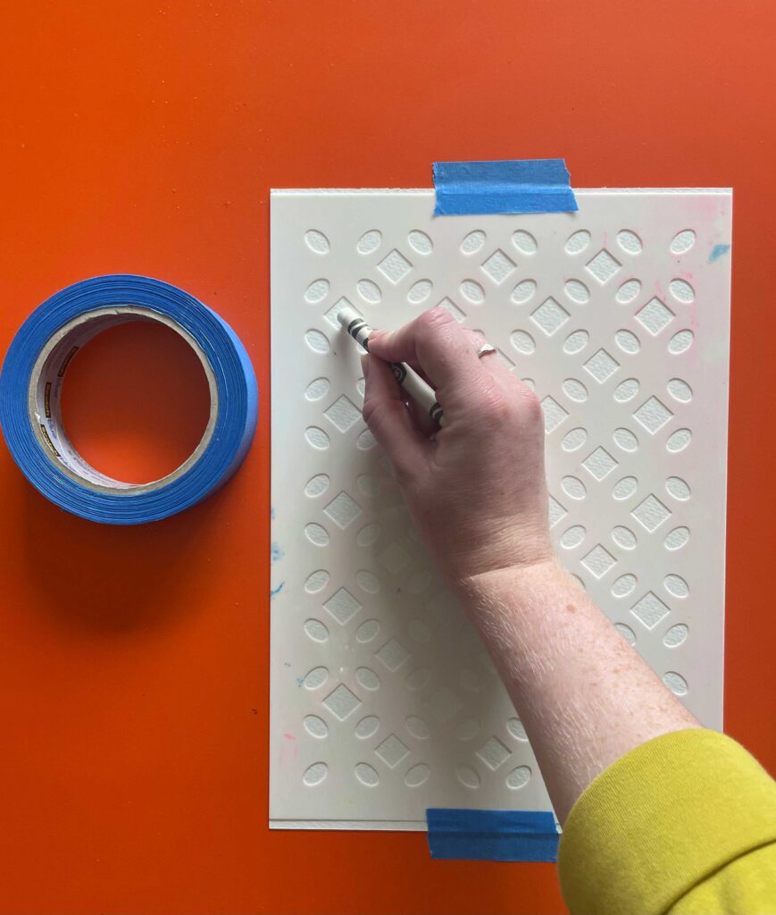 Using a wax crayon to colour in the gaps