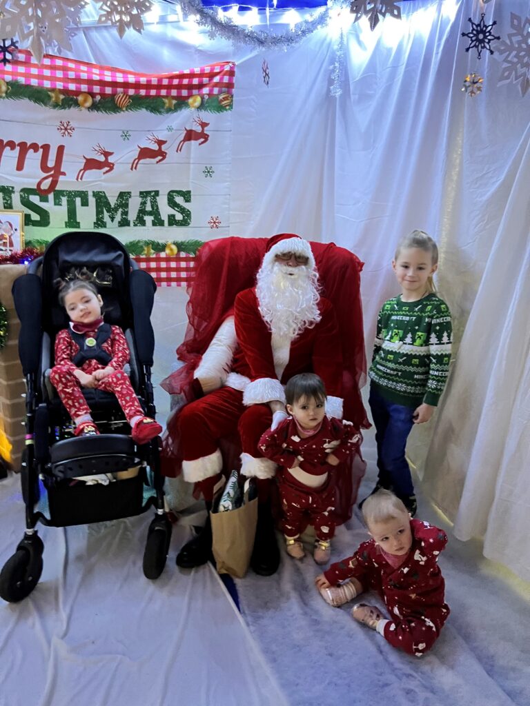 Verity and her siblings meeting Santa at a Sense Christmas Family Day.