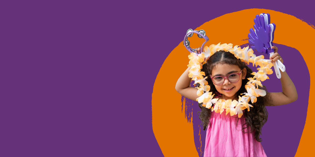 A young girl with dark curly hair holds a flower garland and tambourine.