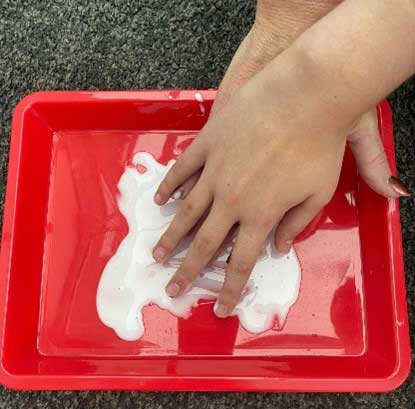 Getting hands into a tray of glue