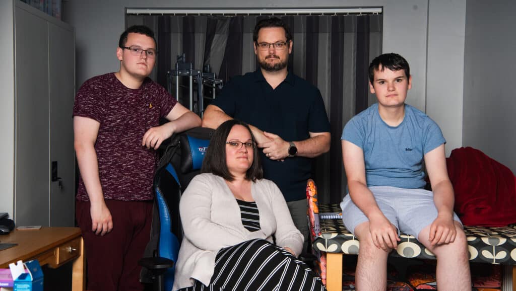 A mum, a dad and their two sons in their living room