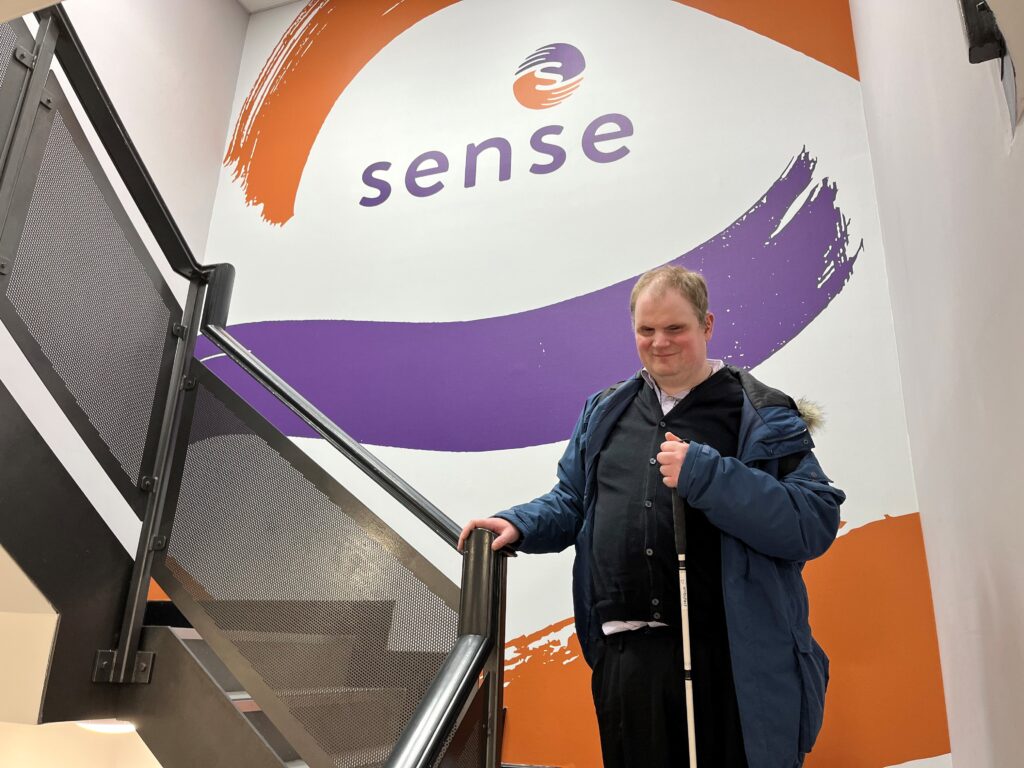 Steven Morris, the author of the article, standing on a staircase in front of a large Sense logo.