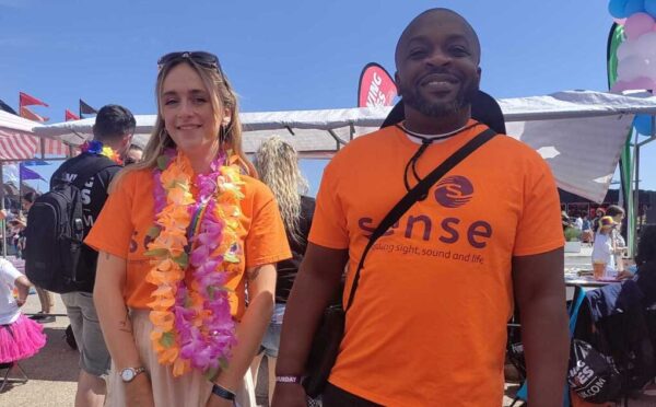 A man and a woman wearing Sense shirts