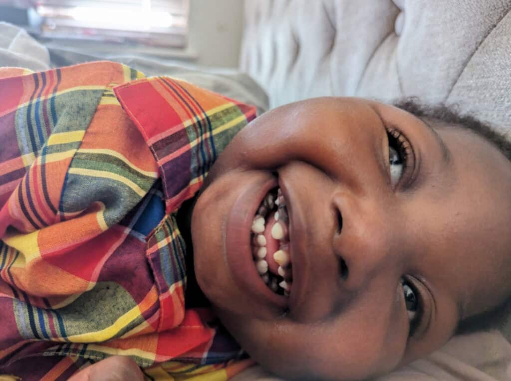 A young boy smiling at the camera