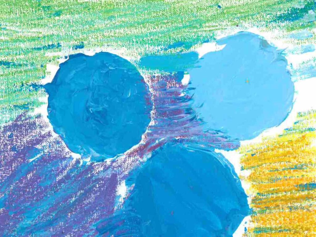 An ombre effect of green, blue and turquoises with three painted circles