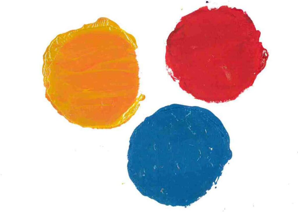 Three painted circles in orange, red and blue
