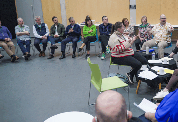 A group of people are talking in a room